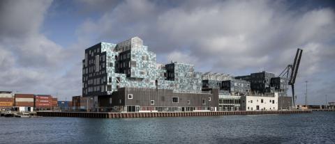 The school building’s unique facade is covered in 12,000 solar panels, each individually angled to create a sequin-like effect,
