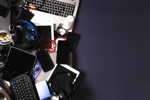 Old computers, digital tablets, mobile phones, many used electronic gadgets devices, broken household and appliances on gray background