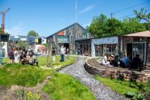 Circular town scene with grass, houses and trees