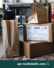 Two paper bags and two cardboard boxes, one with a postal sticker.