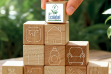 Small pyramid of wooden building blocks, with the Ecolabel logo on the top one