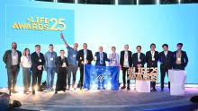 Men and women standing smiling on a stage, with the words LIFE Awards 2025 