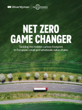 The words 'Net zero game changer' against a background of green grass and a road 