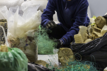 Person sorting plastics and fishing nets