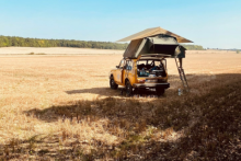 Photo of a jeep with a tent on its roof