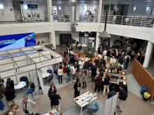 A large, two storey meeting room, with stands and people